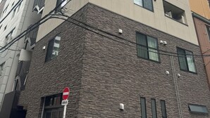 A multi-story building with a stone facade and multiple windows. - SOLASIA residence Kitaueno501 (Tokyo)
