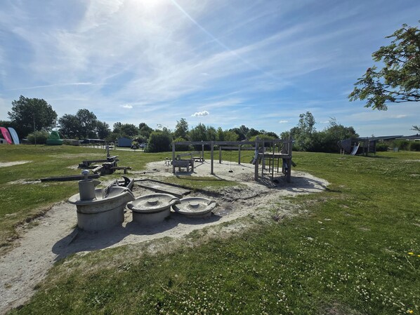 A playground with swings, slides, and climbing structures.