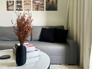 Deluxe Apartment, Balcony, City View | Living area | 50-inch Smart TV with digital channels - Cozy apartment near Burj Khalifa (Dubai)