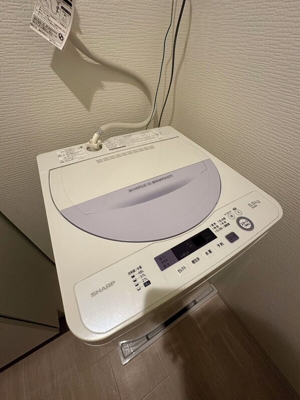 A SHARP digital scale with a display and buttons, placed on a tiled floor against a textured wall. - SOLASIA residence Kitaueno601 (Tokyo)