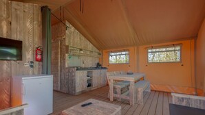 A tented accommodation with a kitchen area, dining space, and a small seating area. - Safari Tent Near Biesbosch & Breda (Oosterhout)