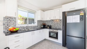 Fridge, microwave, oven, stovetop - Nest on Nelson, 7 Nelson St - boat parking, Wi-Fi, games room (Nelson Bay)