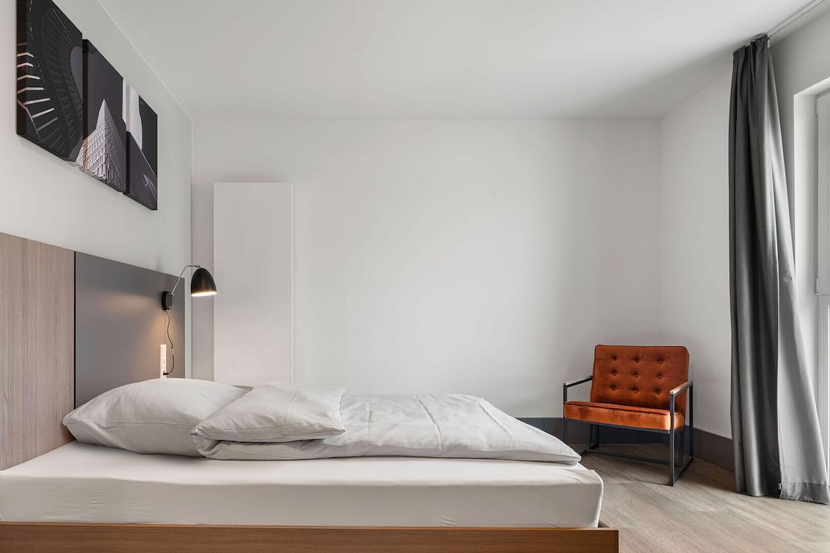 Hypo-allergenic bedding, desk, laptop workspace, blackout curtains