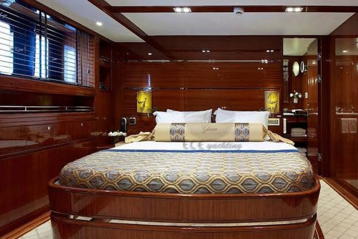 A large, ornate bed with a patterned bedspread and a decorative headboard.