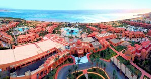 A resort with multiple swimming pools, palm trees, and a beach view. - Swisstouch Oriental Resort Marsa Alam - All inclusive (El Quseir)