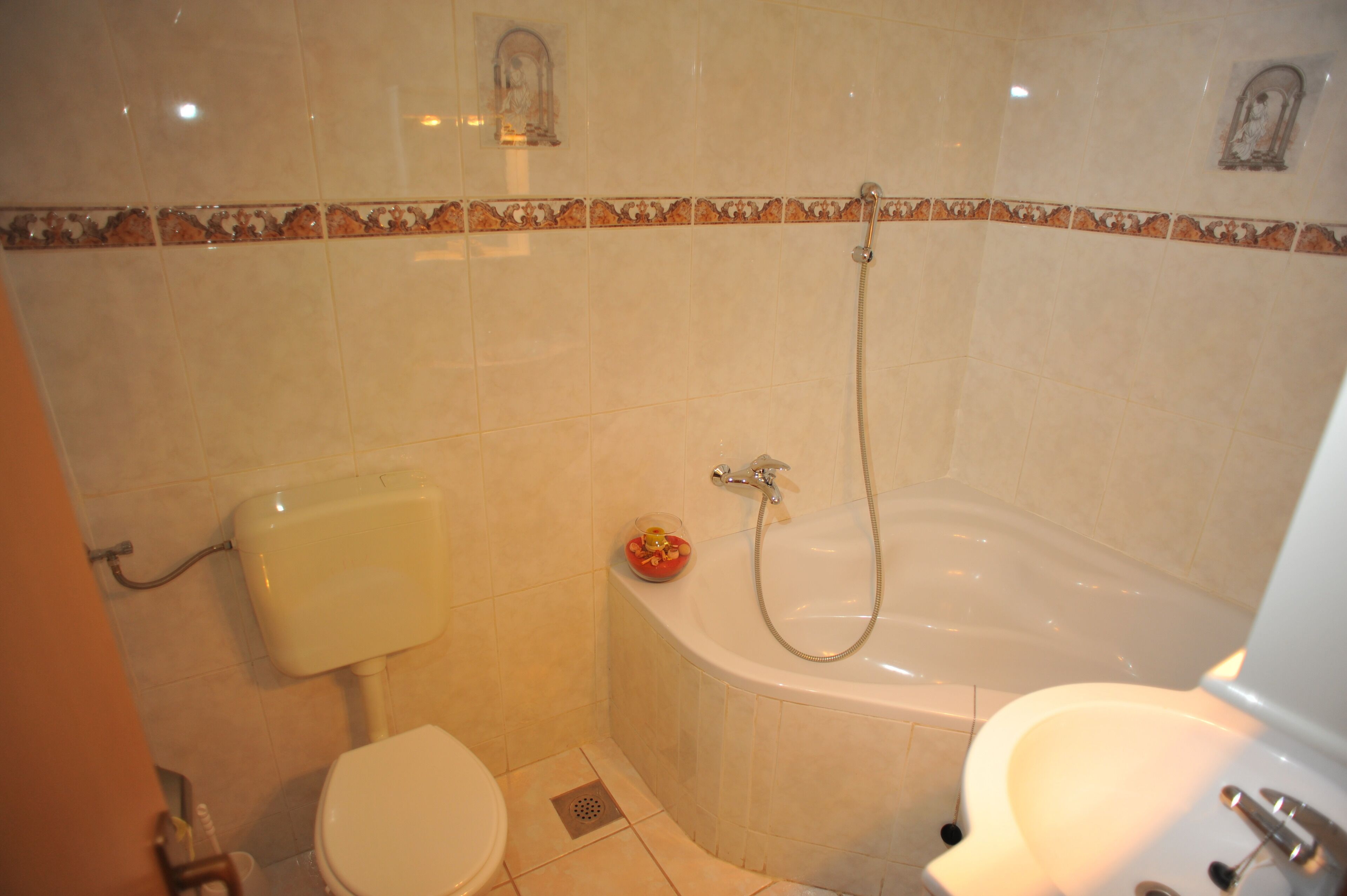 A bathroom with a toilet, a sink, and a bathtub.