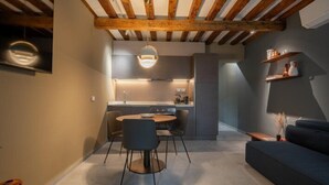 A modern kitchen with a dining area and a sofa. - Venice Jewel Canal View by Wonderful Italy (Venice)