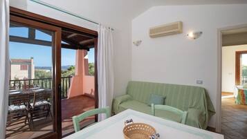 Apartment, Sea View | Living area | 35-inch TV with digital channels