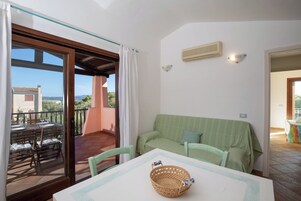 Apartment, Sea View | Living area | 35-inch TV with digital channels