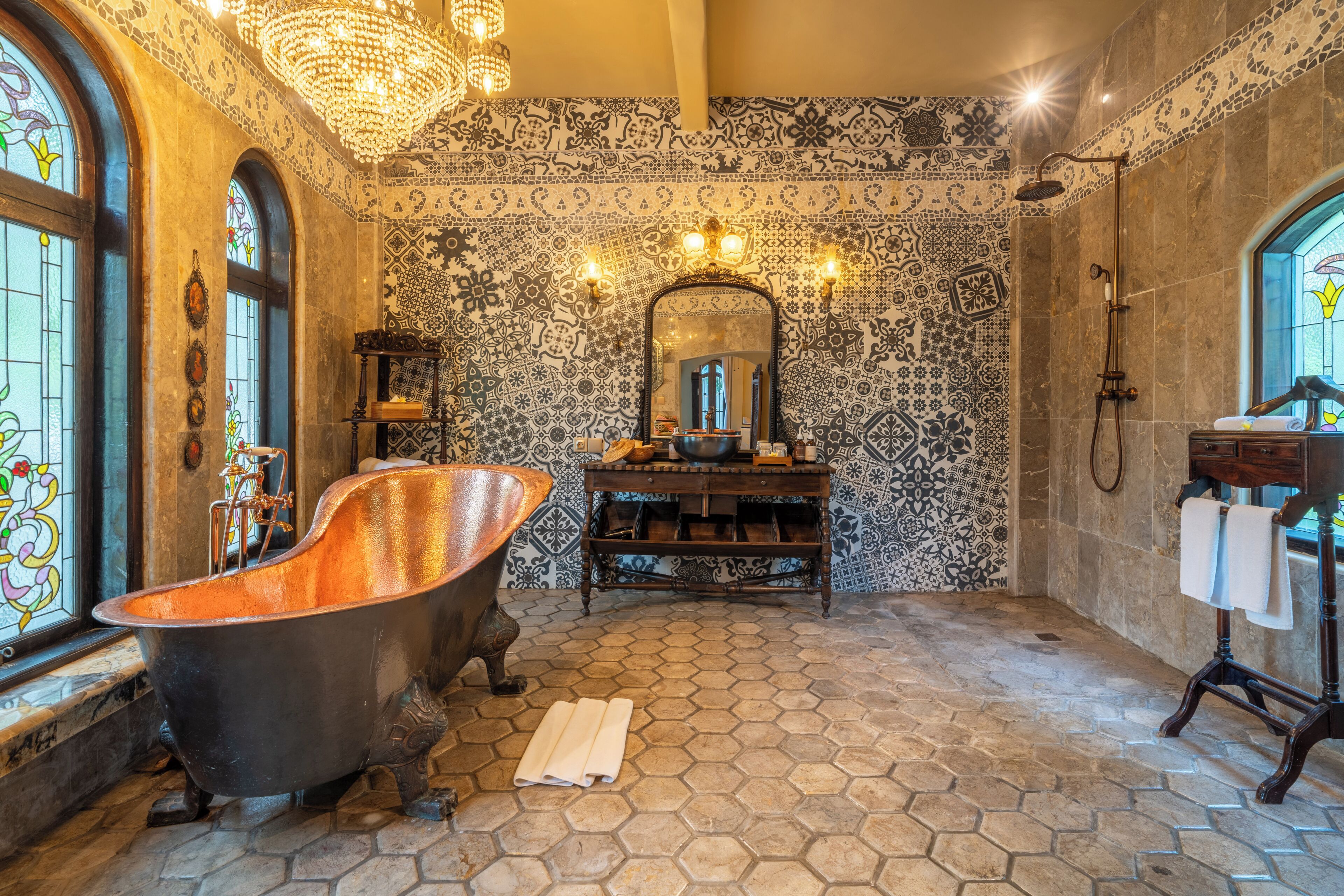 A bathroom with a freestanding bathtub, a vanity with a mirror, and a shower area.