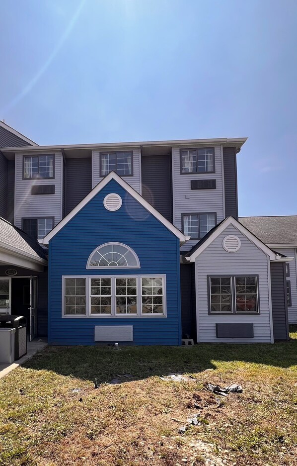 A two-story building with a blue and gray exterior.
