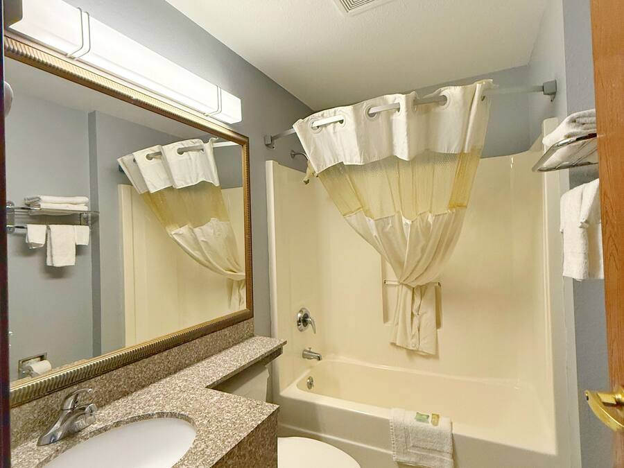 A bathroom with a sink, toilet, and bathtub.