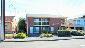 A two-story building with a sign reading 'The Commodore.'