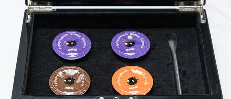 A black box with four coffee capsules labeled "ESPRESSO Liquid Coffee Concentrate" in a hotel collection.