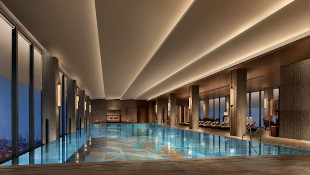 A modern indoor swimming pool with a city view, large windows, and a minimalist design. - The Perennial Tianjin, A JdV by Hyatt Hotel (Tianjin)
