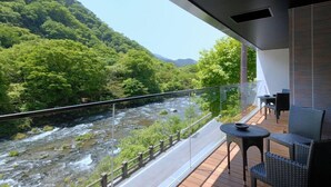 A balcony with a view of a river and forested hills. - Kozuchi No Yado Tsurukame Daikichi (Nikko)