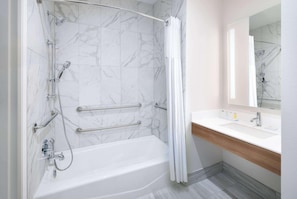 A modern bathroom with a bathtub, shower, and vanity. - Microtel Inn & Suites By Wyndham Amarillo West (Amarillo)