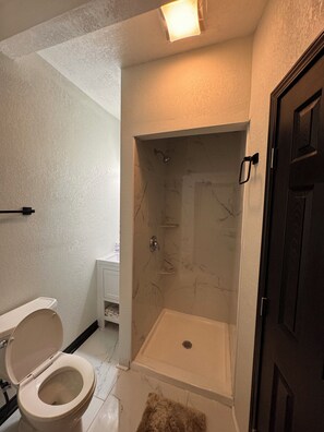 Een douche, een haardroger, handdoeken, toiletpapier