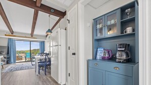 A modern kitchen with a blue cabinet, a coffee maker, and a kettle. - Pool, Pickleball, Hot Tub, Lakeview- Lakecation (Kimberling City)