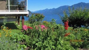 A modern house with a balcony overlooking a lake and mountains. - Vacation Home For Rent - Ainsworth BC (Ainsworth)