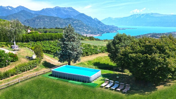 A swimming pool with a view of mountains and a lake.