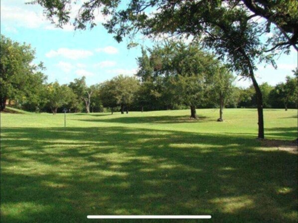 A grassy park with trees and a clear sky. - Stay for 2, Hot Tub, Billiards, Fireplace, Huge (Comanche County)