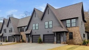 A row of modern, two-story houses with grey siding and dark roofs, featuring multiple garage doors and a well-maintained lawn. - Aubie’s Favorite Place near Campus and Tiger Town with 2 King & 2 Queen beds  (Auburn)