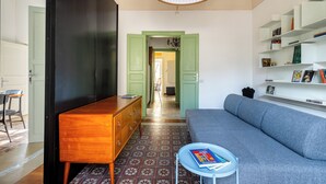A modern living room with a sofa, a wooden cabinet, and a bookshelf. - Eleganza in Centro a Cefalù by Wonderful Italy (Cefalù)