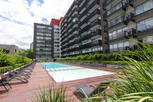 Enjoy a refreshing dip in the rooftop pool surrounded by comfortable lounge chairs and take in the views from the balconies.