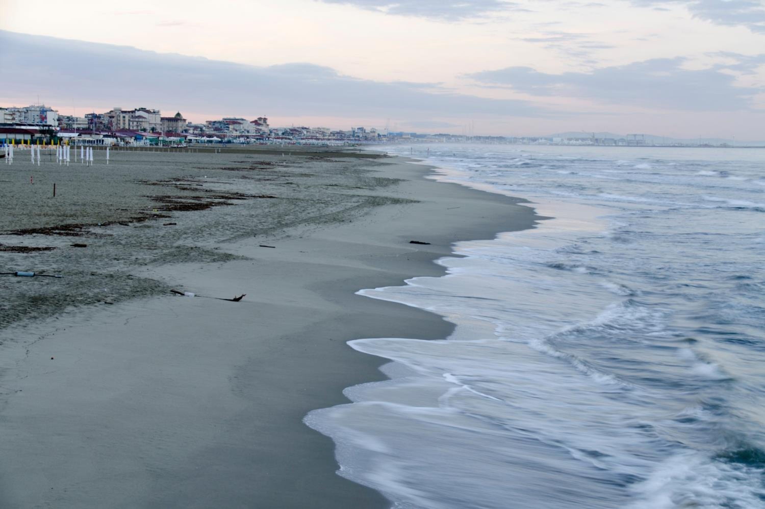 A beach with a sandy shore and waves.