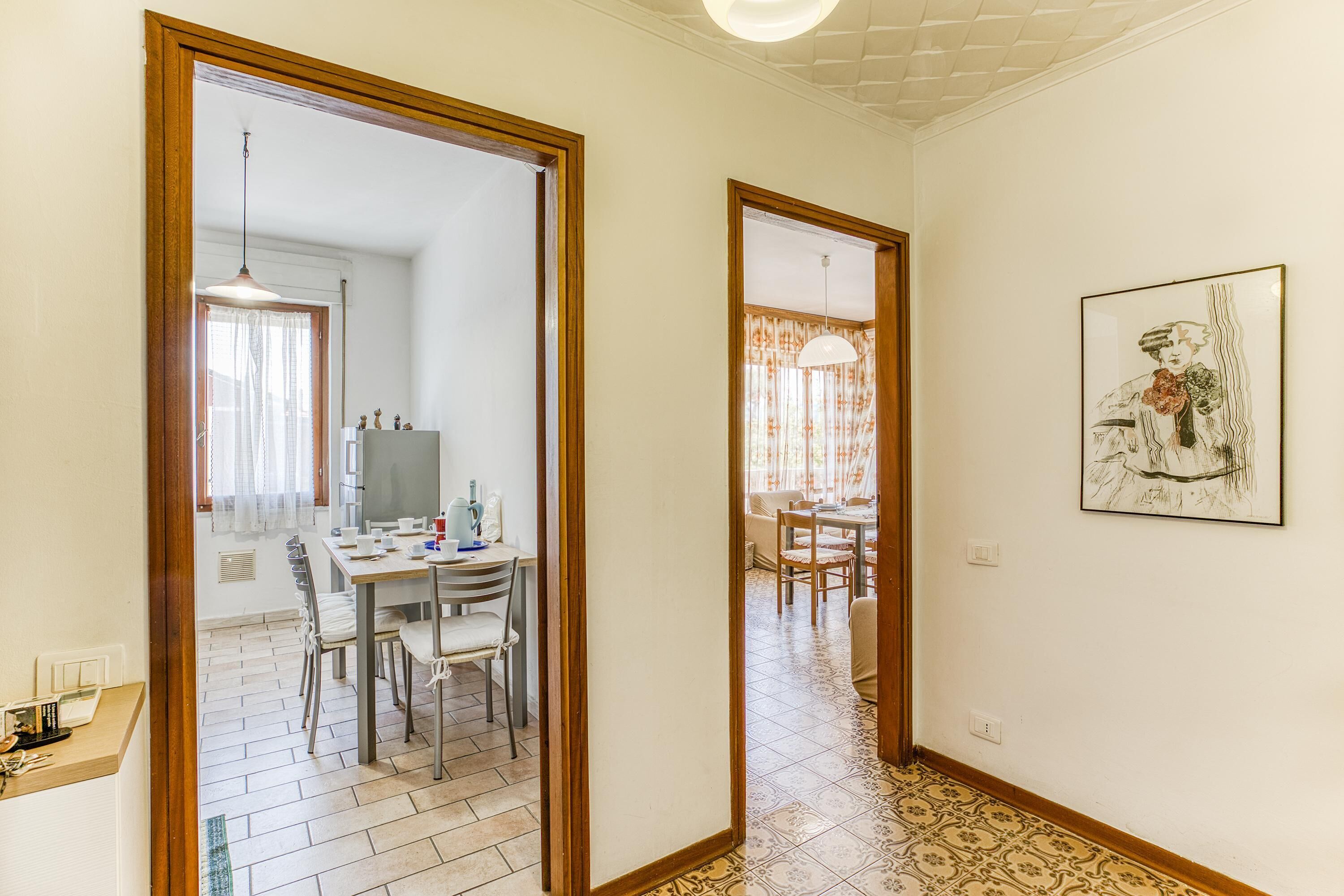 Un pasillo con comedor, cocina y sala de estar.