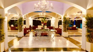A spacious lobby with a central ornate table, surrounded by seating, and a chandelier. - Marbella Resort 5 Pool Whirlpool Sauna (Marbella)