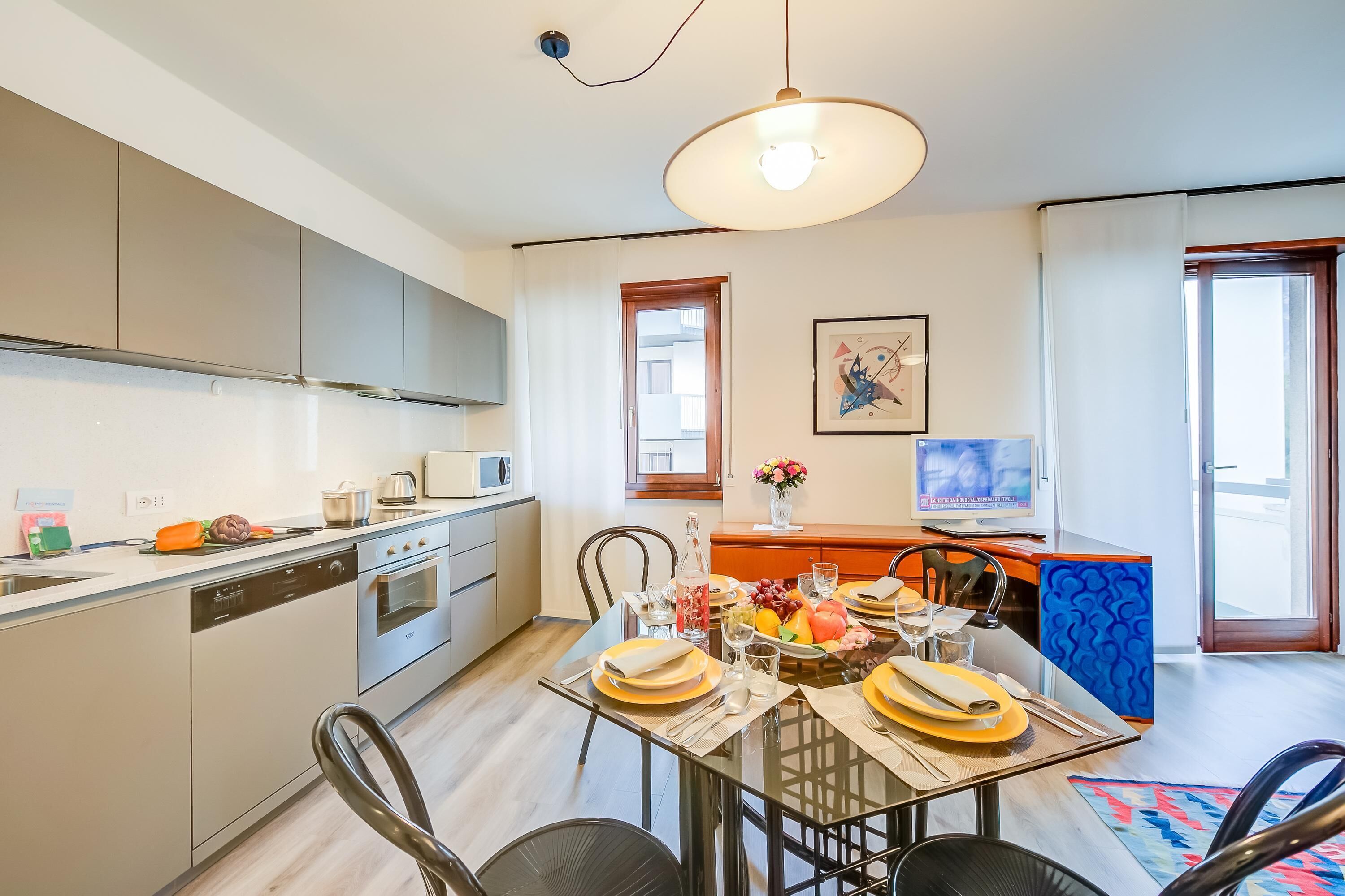 A modern kitchen with a dining area set for a meal.