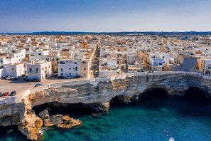 A coastal town with a prominent sea wall and a clear view of the sea.