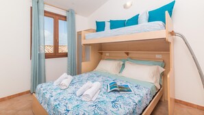 A bunk bed room with a window, curtains, and a book on the bed. - Nicole House With Stunning View And Pool (Badesi)