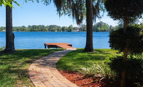 Lakeside Retreat~ Large home with pool, dock, game room and balcony on lakefront