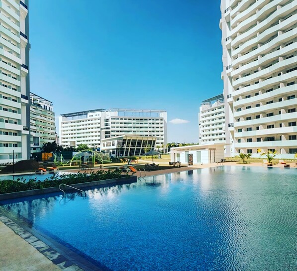 2 outdoor pools, open 7:00 AM to 9:30 PM, pool umbrellas, sun loungers - Acellyne's Suites at The Residences (Quezon City)