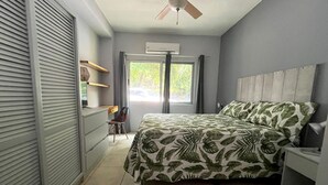 A bedroom with a bed, a desk, and a chair. - Villa Perla ~ Beachfront getaway for two at Los Almendros de Ocotal. (Playas Del Coco)