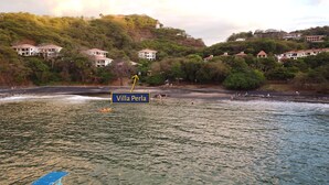 A coastal area with villas, a beach, and a lighthouse. - Villa Perla ~ Beachfront getaway for two at Los Almendros de Ocotal. (Playas Del Coco)