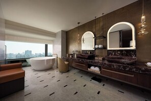 A modern bathroom with a large bathtub, dual sinks, and a vanity with a mirror. - Jin Jiang Hua Ting Hotel and Towers (Shanghai)