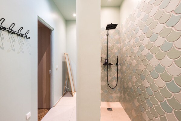 A bathroom with a shower, a wall-mounted towel rack, and a wooden easel. - St Honoré Palace - Spacious - by Mon Petit Faré (Paris)