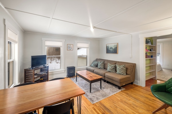 Bright and cozy living room and dining room. Comfortable couch with a smart TV