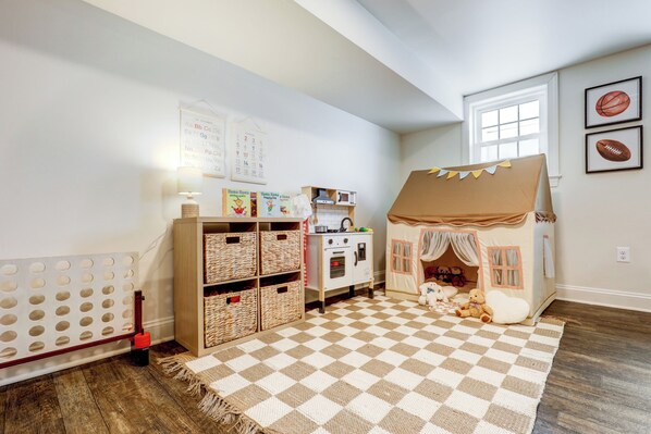A child's playroom with a checkered floor, a playhouse, and educational posters. - Spacious 5bdrm house with AC and WiFi /Family Friendly/Fire Pit /HOT TUB (Gordonville)