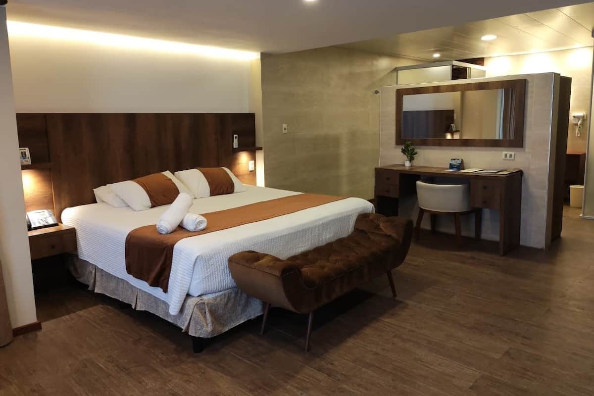 Deluxe Room, 1 King Bed, Pool View | Bathroom | Rainfall showerhead, hair dryer, soap, shampoo