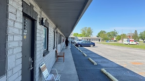 A motel with a covered walkway, a parking lot, and a U-Haul truck.