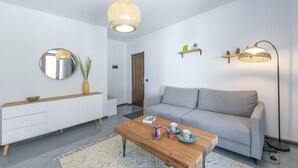 A modern living room with a sofa, coffee table, and decorative items. - The Rock View in Arco (Arco)