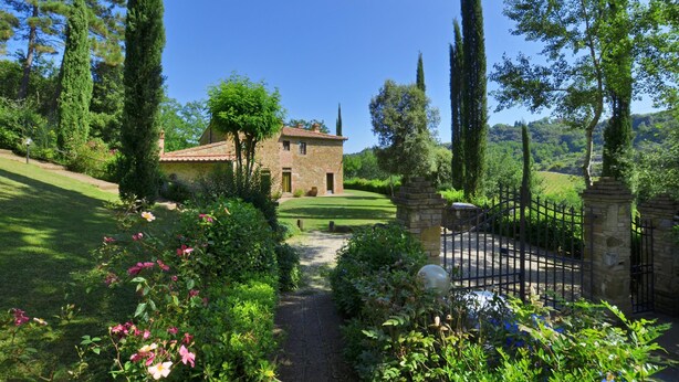 A stone house with a tiled roof, surrounded by lush greenery and tall trees. - Villa Casacheta in Montaione (Montaione)