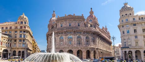 A historic building with a central fountain, surrounded by a circular plaza.