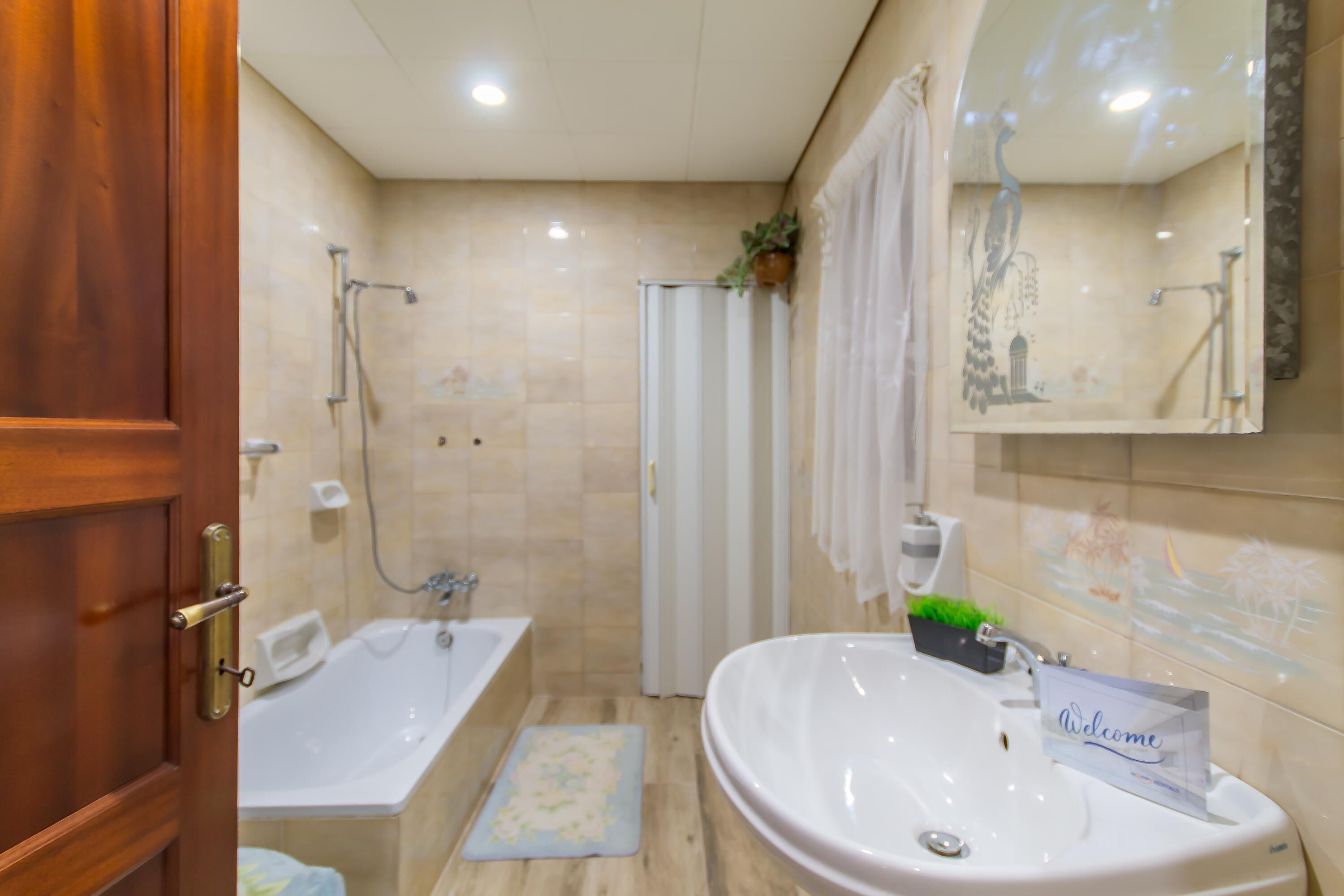 A bathroom with a bathtub, a sink, and a shower.