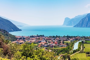 A coastal town with a river, buildings, and mountains.